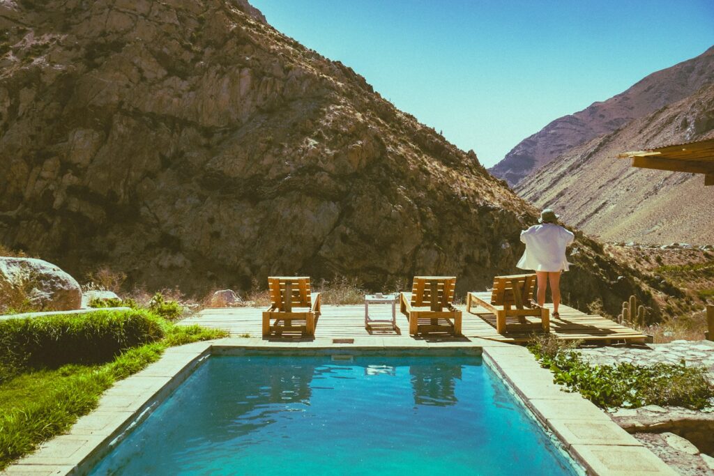 A man sitting at the edge of a swimming pool