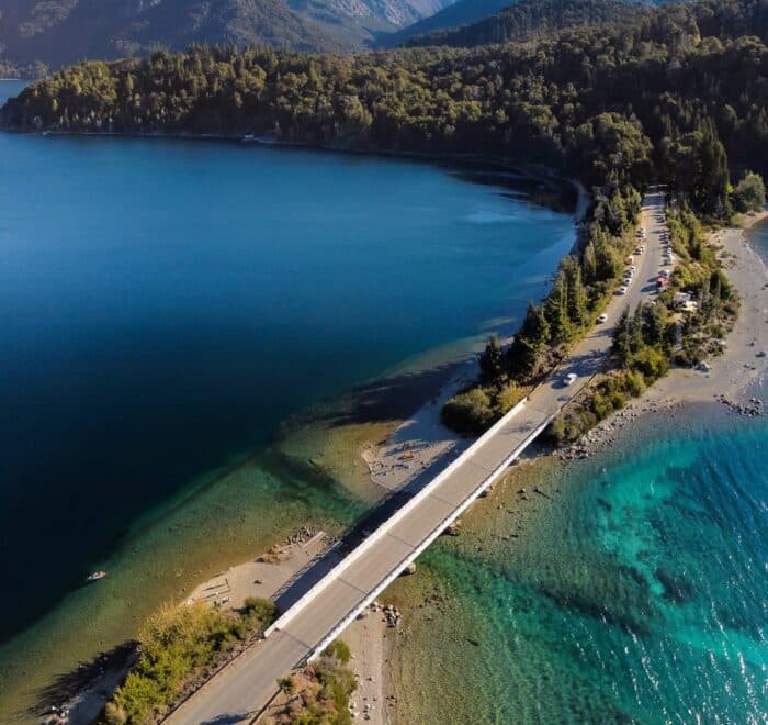 A stunning aerial shot of a picturesque bridge over a lake in Bariloche, Argentina.